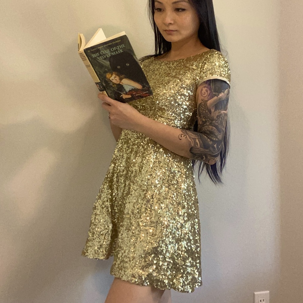 Gold/champagne sequin sparkle mini dress with deep V back. Fit and flare.